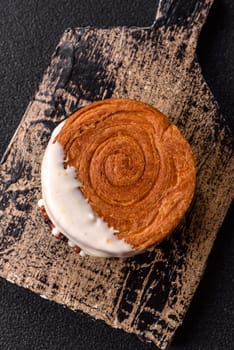 Round sweet New York roll croissant with pistachio cream filling on a dark concrete background