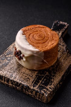Round sweet New York roll croissant with pistachio cream filling on a dark concrete background