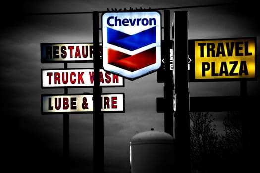 Barstow,United States - December 22,2015: Bright luminous advertisements of various brands and restaurants with seated birds on the fortifications on December 22,2015 in Barstow.