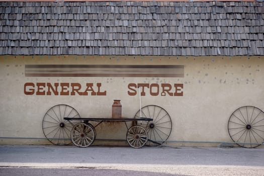 The facade of an old vintage shop with reclined old carriage wheels.