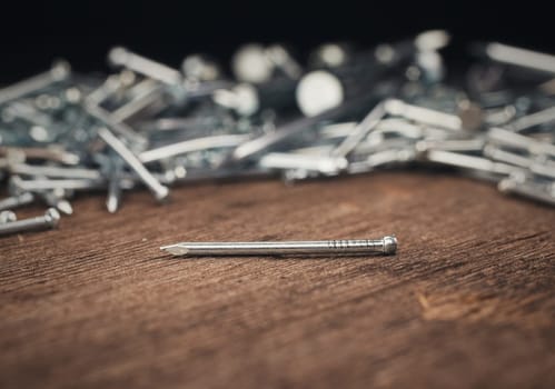 iron nail on a wooden background close up