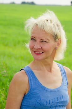 Portrait of a woman amid the summer meadows in the countryside
