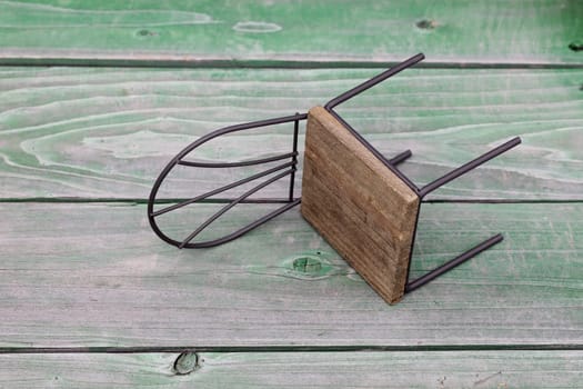 small toy chair on grunge wood background