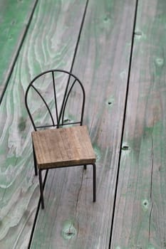 small toy chair on grunge wood background