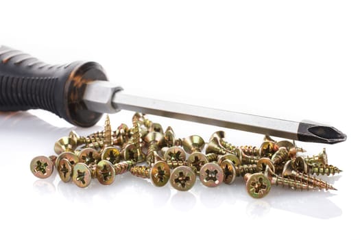 Screws and screwdriver isolated on white background.