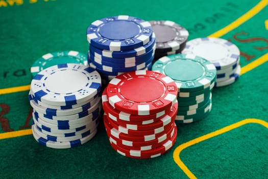 chips for poker on green playing table