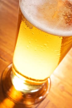 Close-up of a beer glass with foam on the table