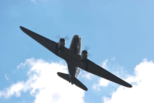 The raisin bomber throws small screens while flying over the former apron of Tempelhof airport for the 60th anniversary of the airlift celebration in Berlin-Tempelhof