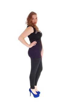 A blond young woman in black tights standing in profile,.looking into the camera, isolated for white background..