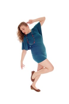 A young blond woman in a green dress and curly blond hair.dancing, looking down, isolated for white background..
