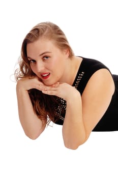 A closeup image of a young blond woman lying on the floor with her .hands under her chin, isolated for white background..