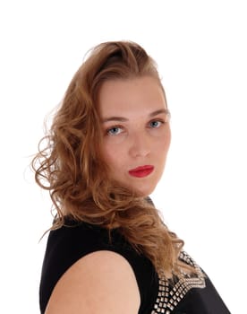 A pretty woman in a black dress blond curly hair.standing in profile, isolated for white background..