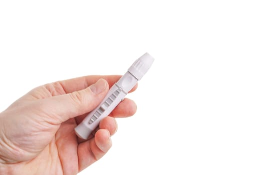 Hand holding lancing for blood glucose test, isolated on white
