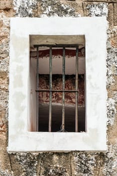 window with bars on, and brick walls