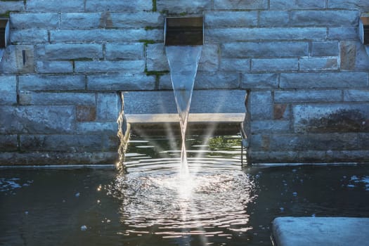 Gardeningly designed water inlet for a garden pond.