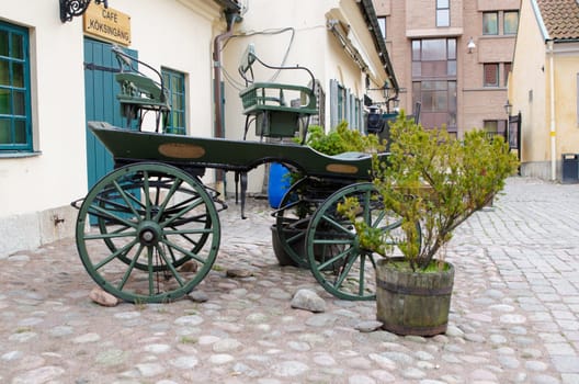 one old horse wagon standing outside the house and the old cafe