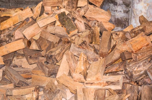 Large pile of chopped firewood for a stove.