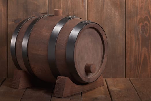 old wooden barrel with wooden plug on dark wood background