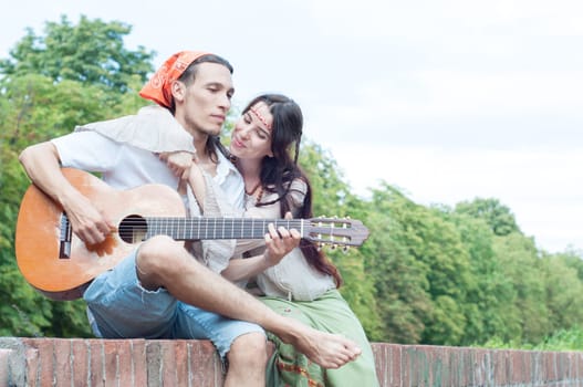 guitarist and his girlfriend in a beautiful day
