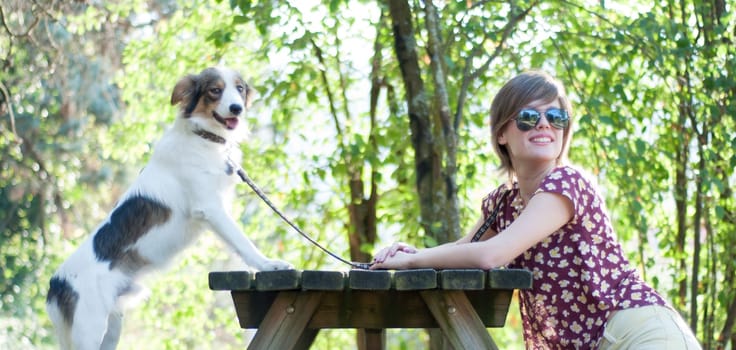 girl and his dog at park in a sunny day