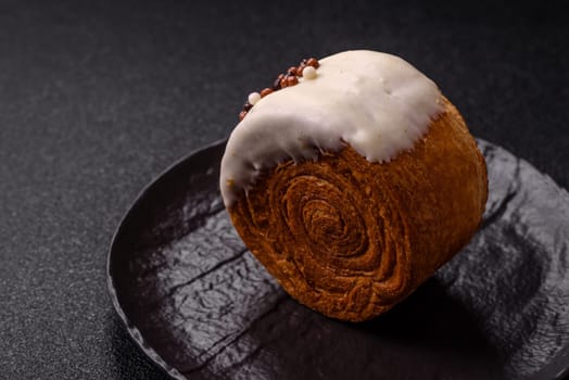 Round sweet New York roll croissant with pistachio cream filling on a dark concrete background