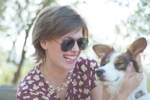 girl and pet dog in a sunny day