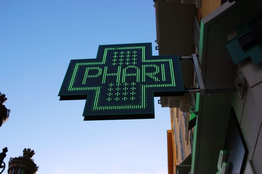 Neon Green Cross Sign Close-up