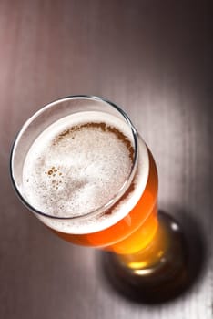 Close-up of a beer glass with foam on the table