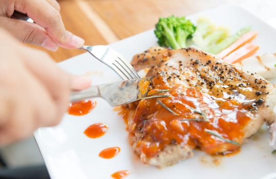 woman eating steak in a restaurant