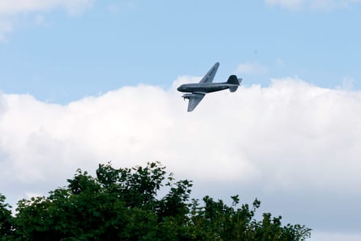 The raisin bomber throws small screens while flying over the former apron of Tempelhof airport for the 60th anniversary of the airlift celebration in Berlin-Tempelhof