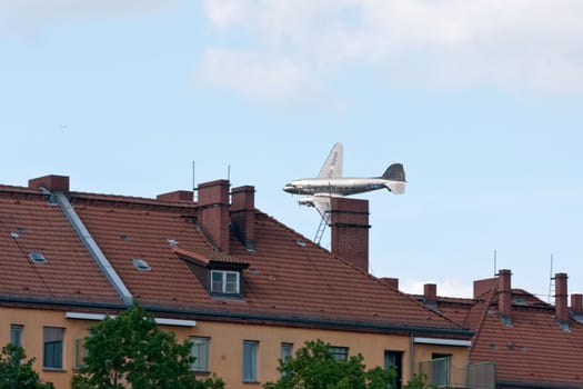 The raisin bomber throws small screens while flying over the former apron of Tempelhof airport for the 60th anniversary of the airlift celebration in Berlin-Tempelhof