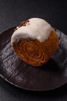 Round sweet New York roll croissant with pistachio cream filling on a dark concrete background