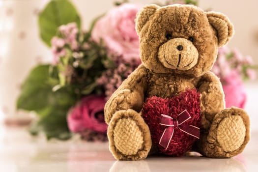 I love you,a teddy bear with heart - in the background a bouquet of flowers,retro