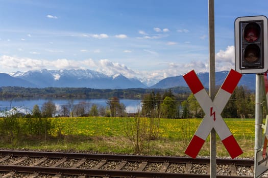 A St. Andrew's Cross at a level crossing in the Alps - lake and mountain view included