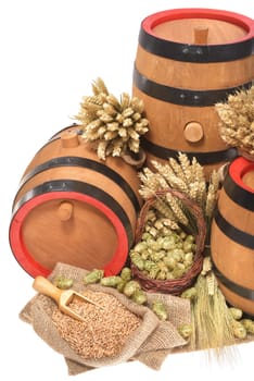 three old beer barrels insulated with wheat,barley,hops and malt On White