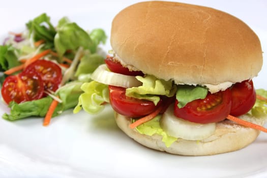 Hamburger rolls topped with tomatoes,onions and salad