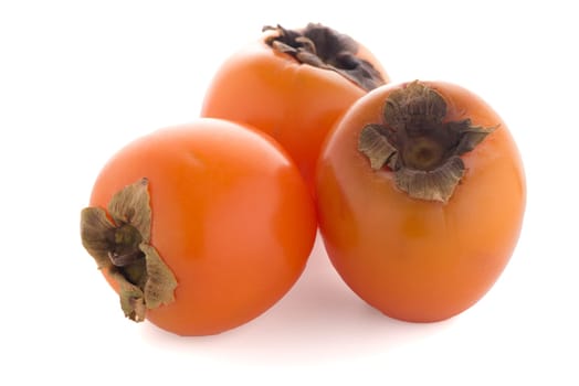 Persimmon fruits on white background.
