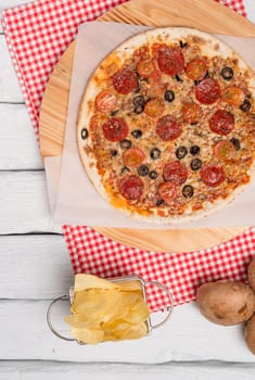 Italian pizza served on wooden table, close-up.