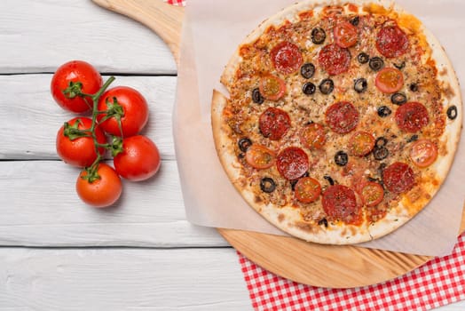 Italian pizza served on wooden table, close-up.