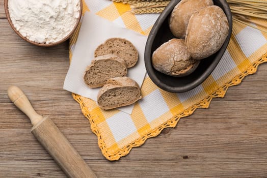 Bread rye spikelets on an old wooden background.