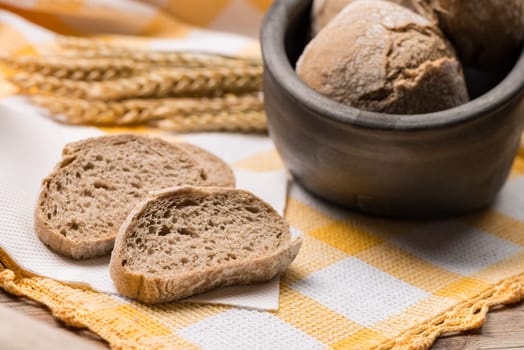 Bread rye spikelets on an old wooden background.