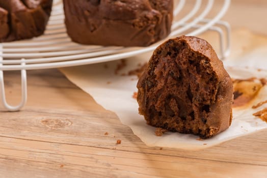 Baked chocolate muffins cooling off on wire mesh