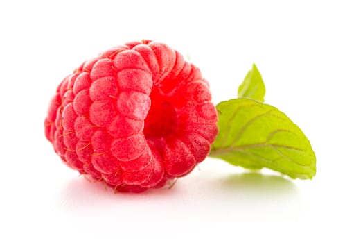 Ripe raspberry with leaf isolated on white background.