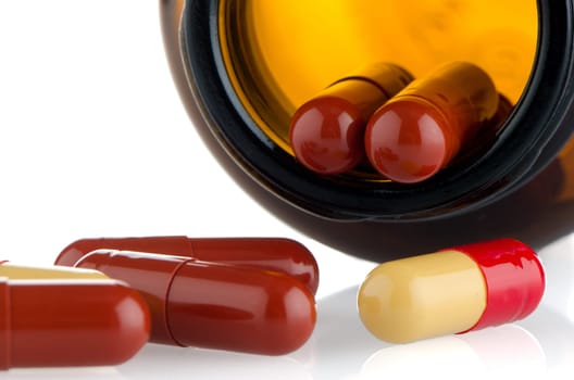 Pills from bottle on the white background.