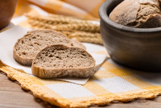 Bread rye spikelets on an old wooden background.