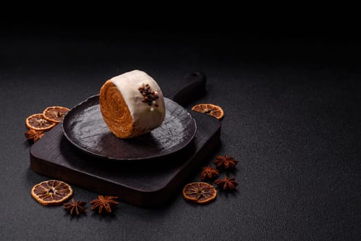 Round sweet New York roll croissant with pistachio cream filling on a dark concrete background