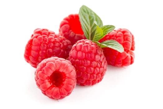 Ripe raspberry with leaf isolated on white background.