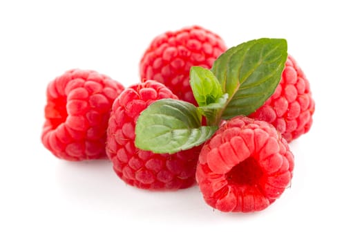 Raspberries with leaves isolated on white background