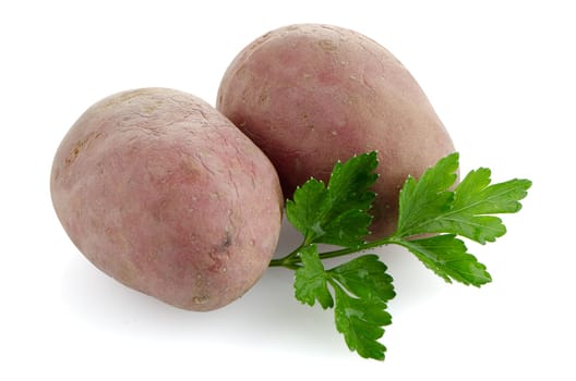 Red potatoes on white reflective background.