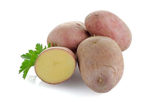 Red potatoes on white reflective background.